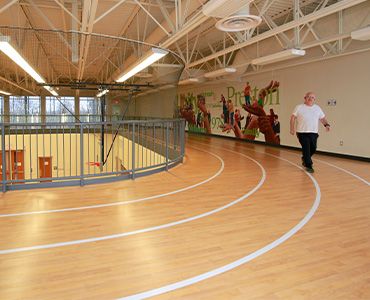 Man walking on indoor track